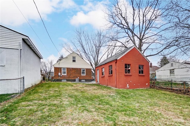 back of property featuring a lawn