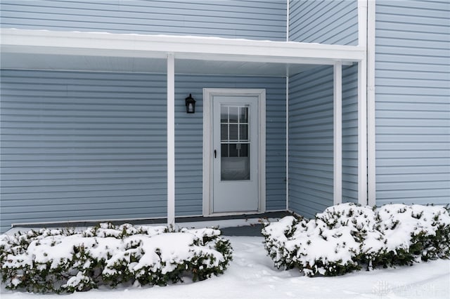 view of snow covered property entrance