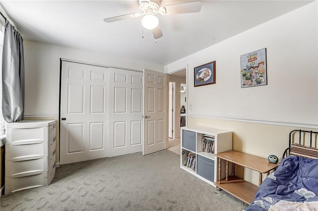 bedroom featuring light carpet, a closet, and ceiling fan