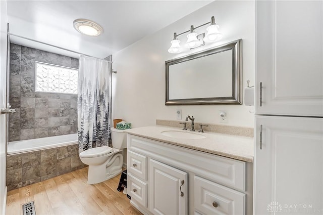 full bathroom featuring shower / bath combination with curtain, wood-type flooring, toilet, and vanity