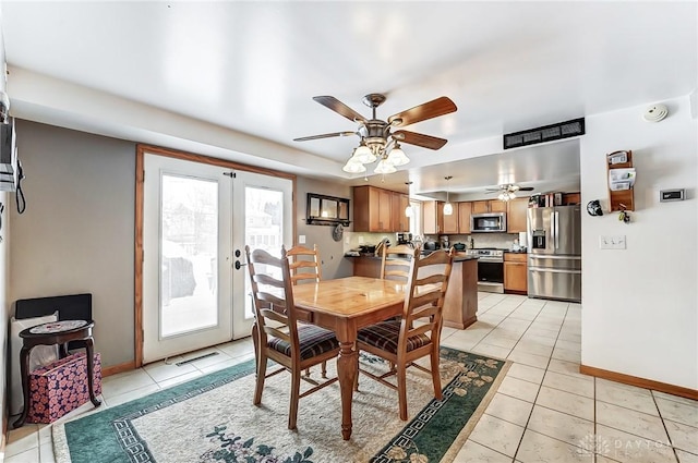 dining room with light tile patterned floors, ceiling fan, and french doors