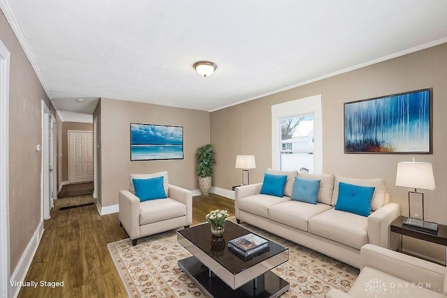 living room featuring hardwood / wood-style floors and crown molding