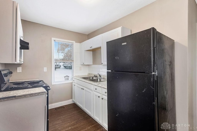 kitchen featuring extractor fan, black refrigerator, electric range oven, sink, and white cabinets