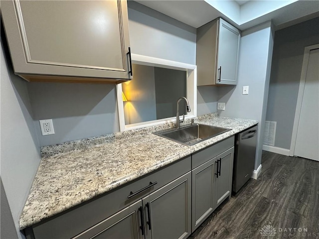 kitchen with dishwasher, gray cabinets, sink, and dark wood-type flooring