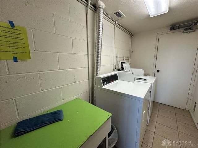 laundry area featuring independent washer and dryer and light tile patterned floors