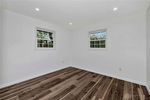 empty room featuring hardwood / wood-style floors and plenty of natural light