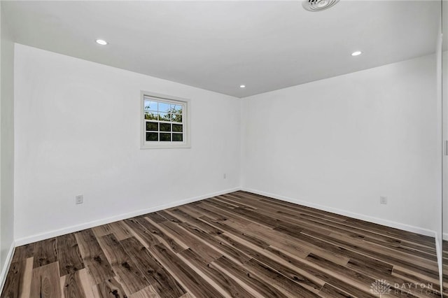 empty room featuring dark hardwood / wood-style flooring