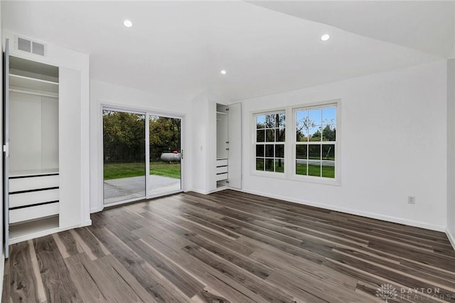 interior space with dark hardwood / wood-style flooring and vaulted ceiling