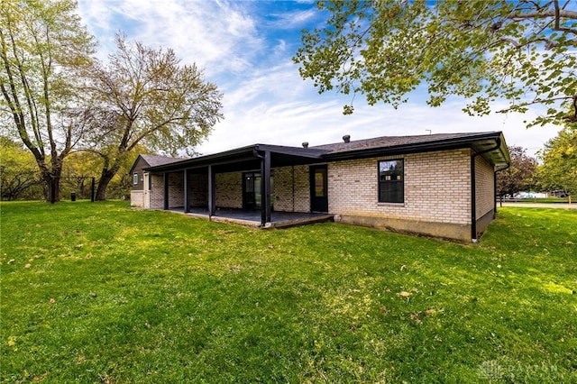 rear view of house with a yard and a patio area