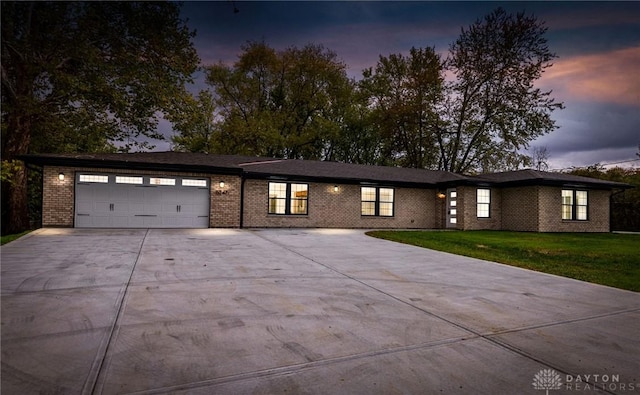 view of front of house with a garage and a yard