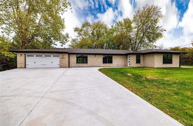 single story home featuring a garage and a front lawn