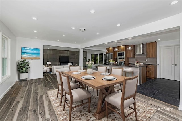 dining space with dark hardwood / wood-style flooring