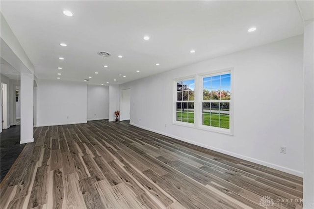 unfurnished living room featuring dark hardwood / wood-style flooring