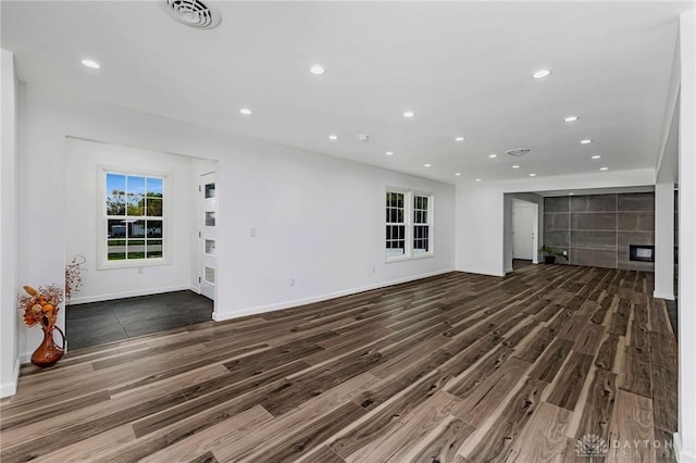 unfurnished living room with dark hardwood / wood-style flooring