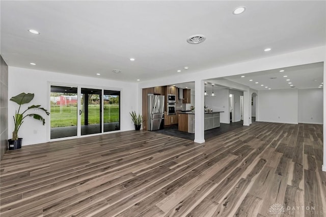 unfurnished living room featuring dark wood-type flooring