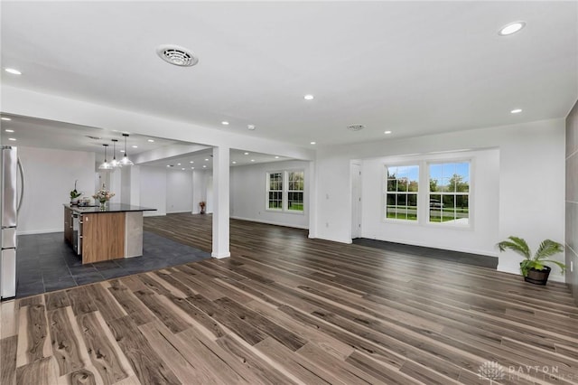 unfurnished living room with dark wood-type flooring