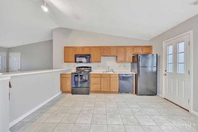 kitchen with sink, a textured ceiling, lofted ceiling, light tile patterned floors, and black appliances