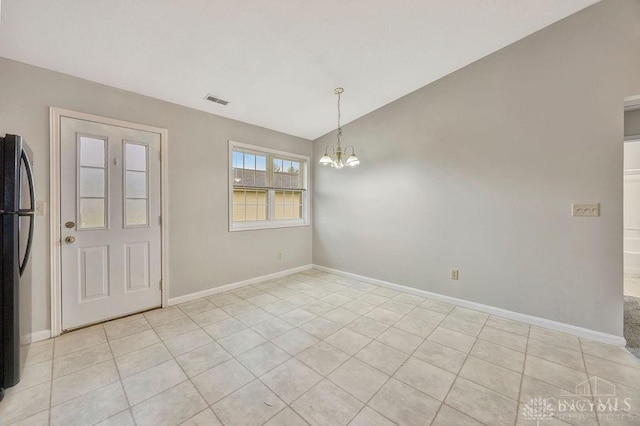 unfurnished dining area featuring light tile patterned floors and an inviting chandelier