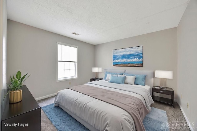 bedroom with carpet flooring and a textured ceiling