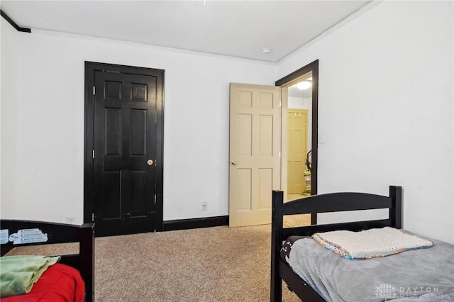 bedroom featuring carpet flooring and crown molding