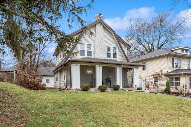 view of front of home with a porch and a front yard