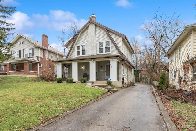 view of front of property with a front lawn and cooling unit