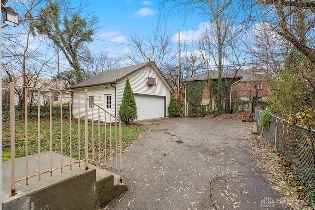 view of side of property featuring an outbuilding and a garage