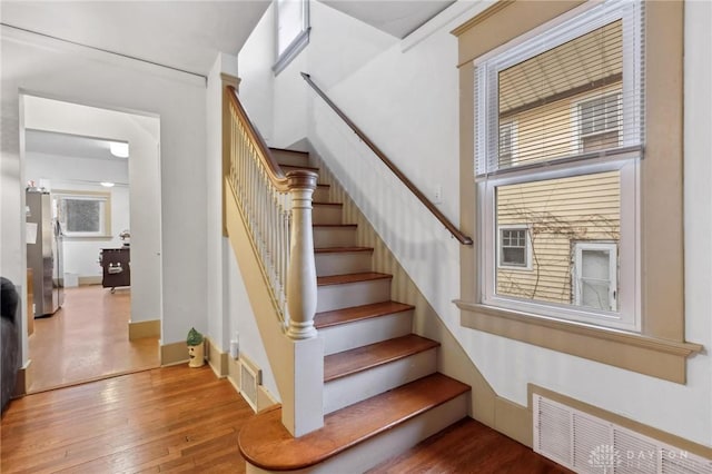 stairs featuring hardwood / wood-style floors