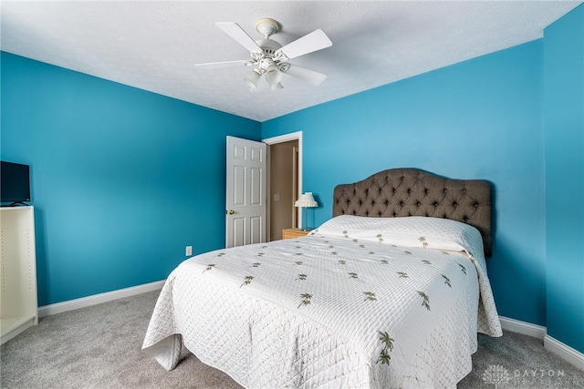 bedroom featuring carpet, a textured ceiling, and ceiling fan