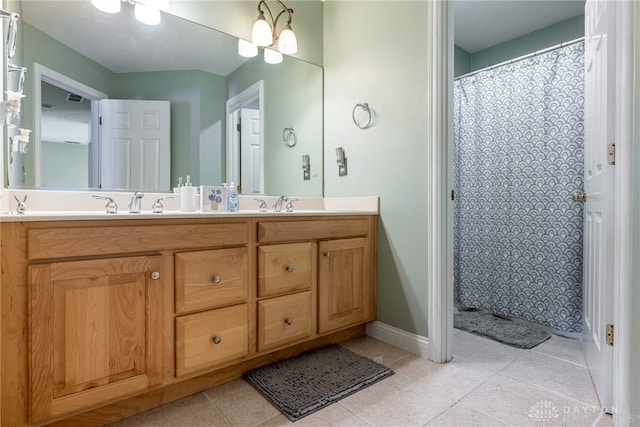 bathroom with a chandelier, vanity, tile patterned floors, and curtained shower