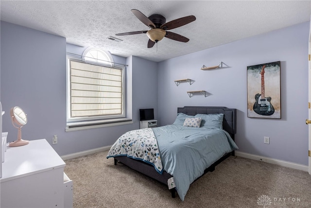 carpeted bedroom with a textured ceiling and ceiling fan