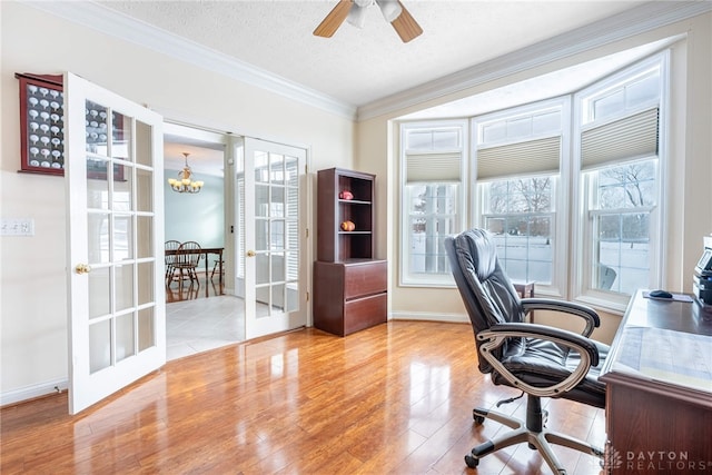 home office featuring ceiling fan with notable chandelier, french doors, a textured ceiling, and light wood-type flooring