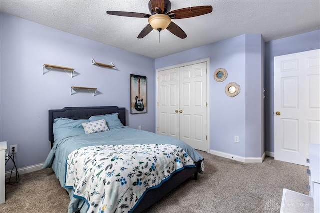 carpeted bedroom with a textured ceiling, a closet, and ceiling fan