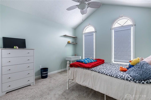 bedroom with multiple windows, ceiling fan, light colored carpet, and lofted ceiling