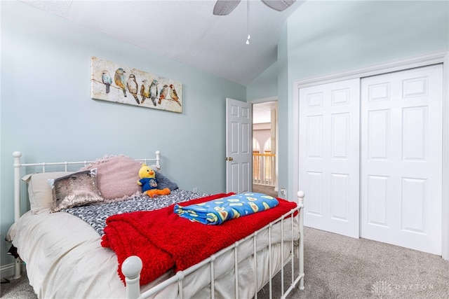 carpeted bedroom with ceiling fan, a closet, and lofted ceiling