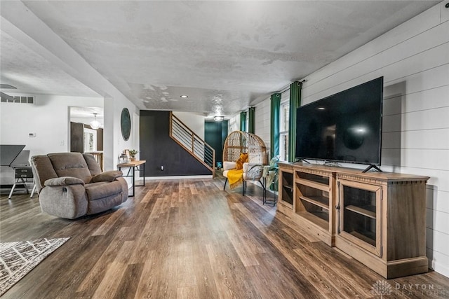 living room featuring wood walls and wood-type flooring