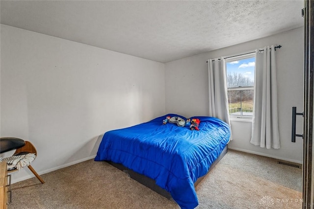 carpeted bedroom with a textured ceiling