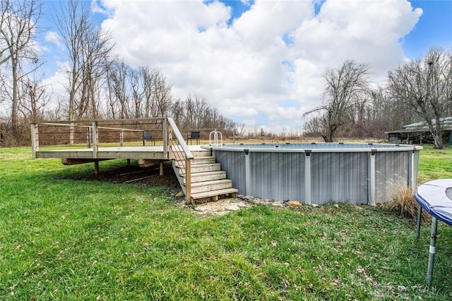 view of yard with a deck and an outdoor pool