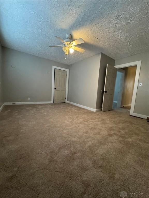 unfurnished room with carpet, a textured ceiling, and ceiling fan