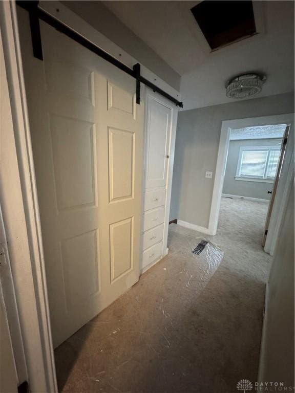 hallway featuring a barn door