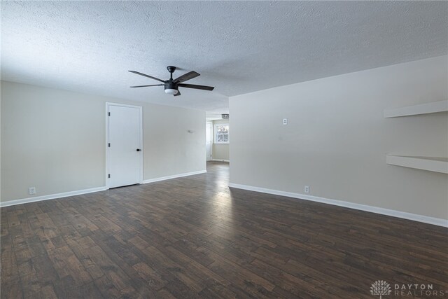 unfurnished room featuring dark hardwood / wood-style floors, ceiling fan, and a textured ceiling