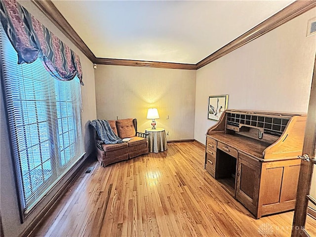 sitting room with crown molding and light hardwood / wood-style floors