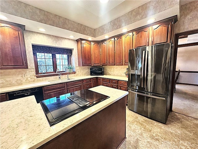 kitchen with decorative backsplash, sink, and black appliances