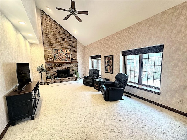 carpeted living room featuring ceiling fan, a fireplace, and high vaulted ceiling