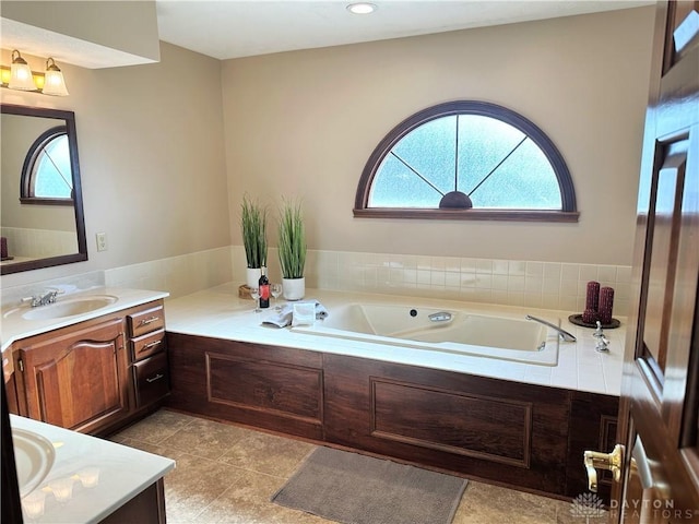 bathroom featuring vanity and a bath