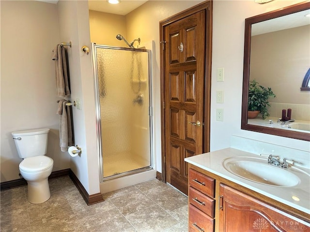 bathroom with vanity, toilet, and walk in shower