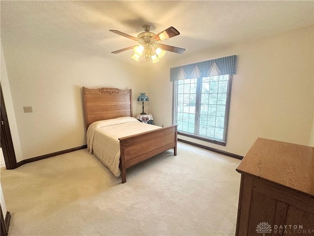 bedroom featuring light carpet and ceiling fan