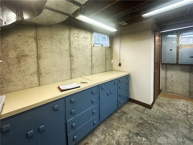 bathroom featuring electric panel and concrete flooring