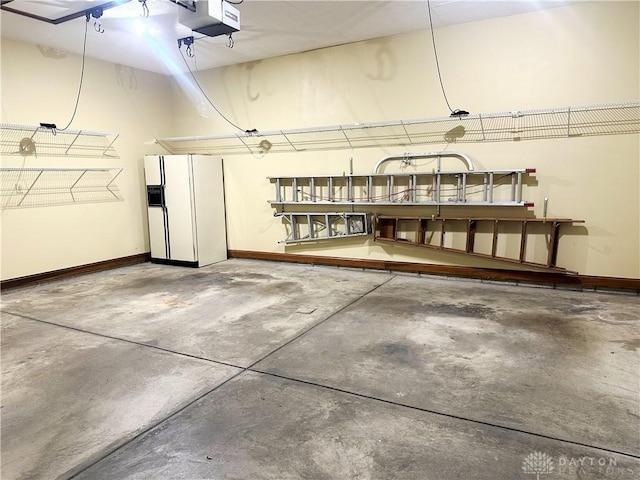 garage with white fridge with ice dispenser and a garage door opener