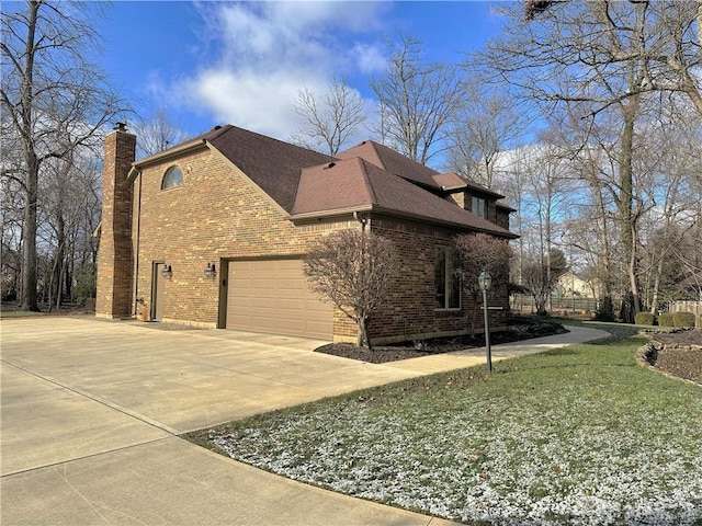 view of side of property with a lawn and a garage